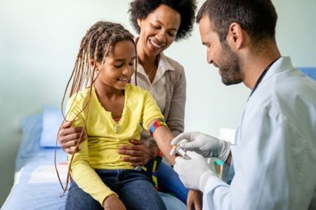 mother daughter in doctors office getting a shot